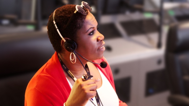 Deborah Mitchell, multimedia producer and Founder of Deborah Mitchell Media and Associates, wearing headset while working on virtual event management